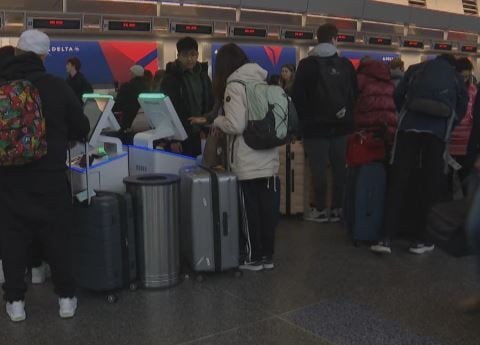 Snow causes big delays at Boston's Logan Airport for holiday travelers