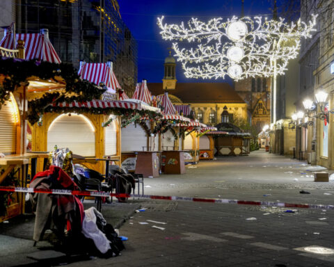 Germans mourn the 5 killed and 200 injured in the apparent attack on a Christmas market