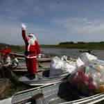 Santa braves the sticky heat of the Amazon jungle to bring gifts to children in remote village