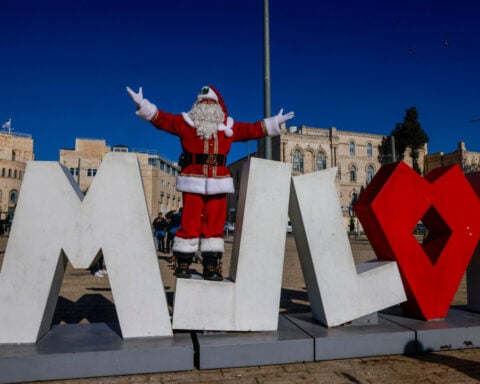 Christians protest in Syrian capital after burning of Christmas tree