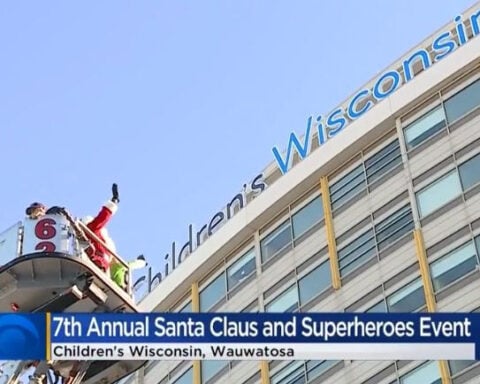 Firefighters hoist Santa, superheroes to wave to patients inside Children's Wisconsin on Christmas