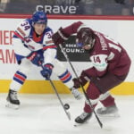 Notre Dame's Danny Nelson scores twice, defending champ US beats Latvia 5-1 in world junior hockey