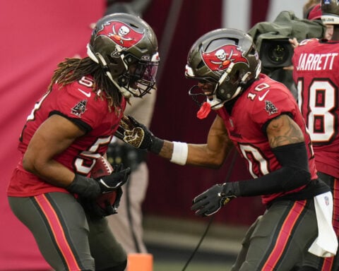 Mayfield throws 5 TD passes and Bucs keep playoff, NFC South hopes alive with 48-14 rout of Panthers