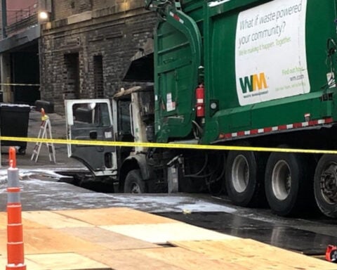 Omaha officials say trash truck driver removed barricade before crashing into sinkhole