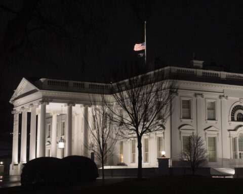 Why are US flags being flown at half-staff on Inauguration Day?