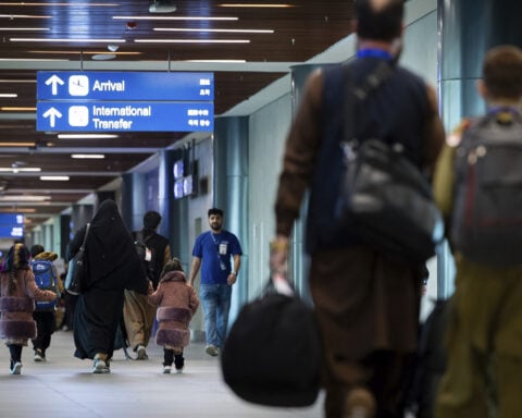 Afghans arrive in the Philippines to complete visa processing for resettlement in US