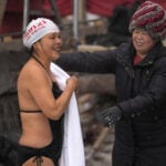 In freezing temperatures, swimmers in China plunge into a river for health and joy