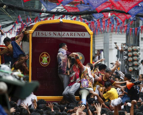 Filipino Catholics pray for good health and peace in huge procession venerating Jesus statue