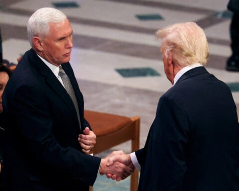 Trump shakes hands with Pence, engages Obama at Carter funeral