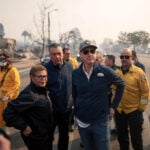 As the L.A. fires rage, Mayor Karen Bass faces fierce criticism for overseas trip, budget cuts