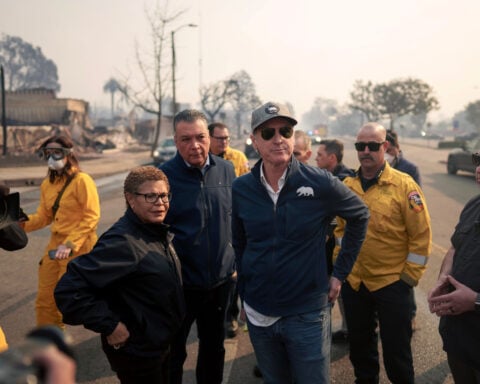 As the L.A. fires rage, Mayor Karen Bass faces fierce criticism for overseas trip, budget cuts