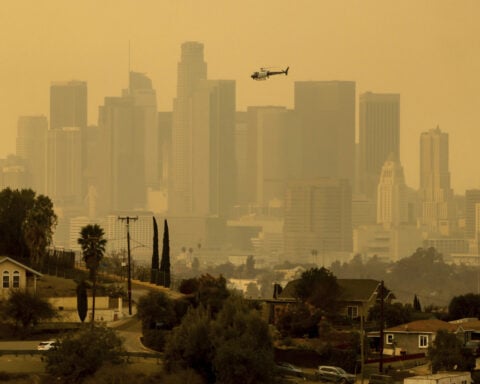 In Los Angeles, people snap up air filters and wear masks against smoke pollution