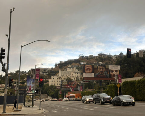 Far from wildfire flames, residents of sunny Los Angeles go about their lives in disquiet and fear