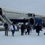 Video shows over 200 Delta airlines passengers evacuating onto snowy tarmac in Atlanta