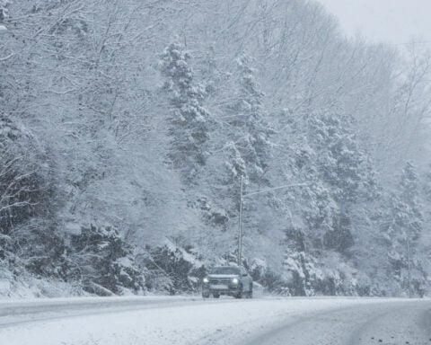 Powerful winter storm dumps heavy snow, causing flight delays, slick roads and school closings