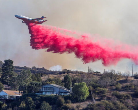 Aerial assault aims to stem LA Palisades fire eastward spread