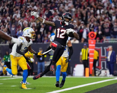 Houston Texans overcome slow start to rout Los Angeles Chargers in chaotic playoff matchup