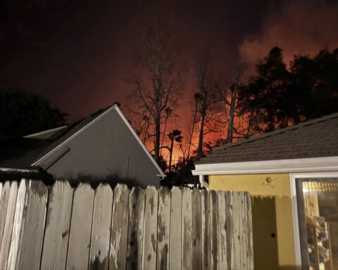 A dad and daughter help evacuees learn whether their homes survived the California wildfires