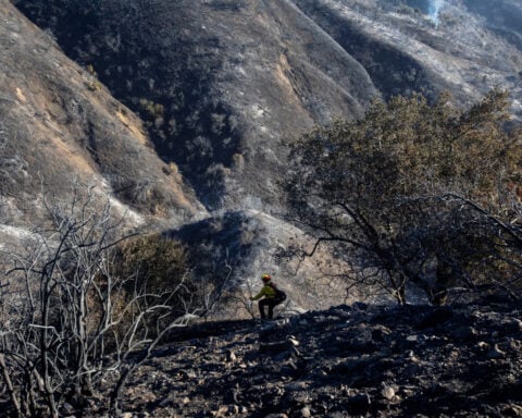 Los Angeles races to contain wildfires before severe winds return