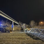 Fencing, roof of Anchorage pedestrian bridge fall in strong wind, closing highway