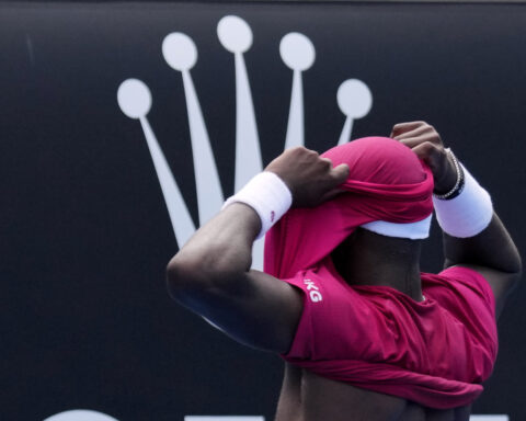 Frances Tiafoe picks up a tough victory after throwing up at the Australian Open