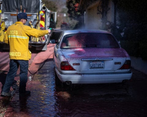 Los Angeles races to contain wildfires before severe winds return