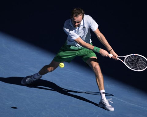 Daniil Medvedev destroys a TV camera attached to the net during his 5-set Australian Open win