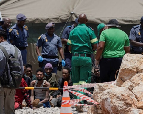 South Africa pulls 36 corpses from illegal mine, arrests 82 survivors