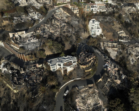Ash and other dangers mean LA area residents who fled fires a week ago won't be going home soon
