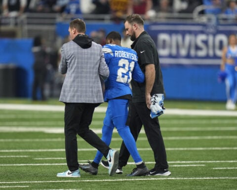 Lions CB Amik Robertson hurt and QB Jared Goff misses a series in playoff game vs. Commanders