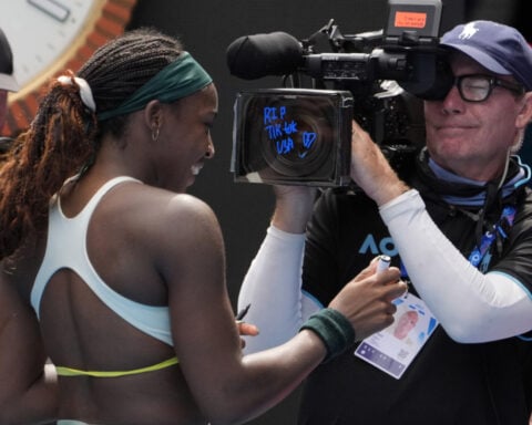 Coco Gauff writes 'RIP TikTok USA' on a TV camera at the Australian Open