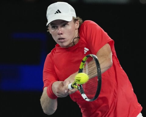 Jannik Sinner gets past Holger Rune at the Australian Open in a match with net and medical delays