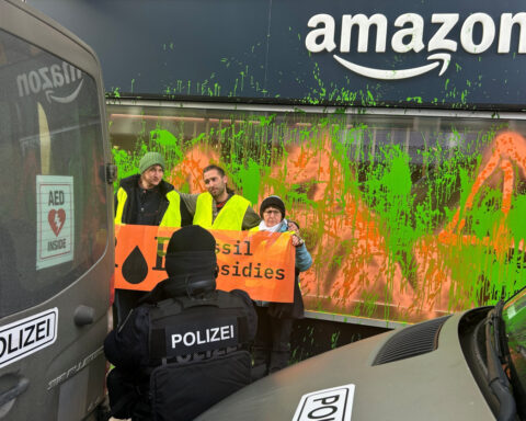 Davos climate activists paint Amazon base green, disrupt helicopters