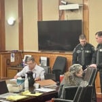 Mother on trial in West Virginia denies locking adopted teens in shed