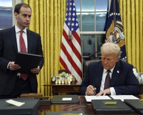 Who's the guy handing Trump those binders of executive orders? Meet Will Scharf