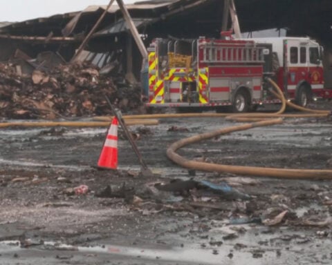 Doctors warn residents to take precautions as recycling plant fire continues to smolder