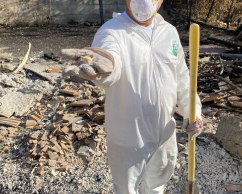 This ‘angel of debris’ digs through burnt rubble to find glimmers of joy for fire victims