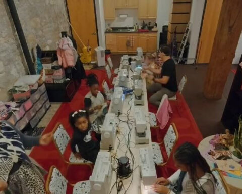 Woman helps kids through sewing