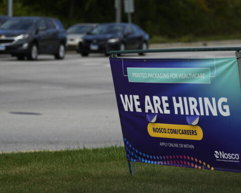The number of Americans seeking jobless benefits falls as employers continue to hold on to workers