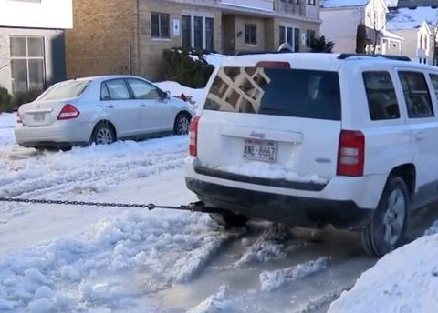 Cars freeze to street after water main break