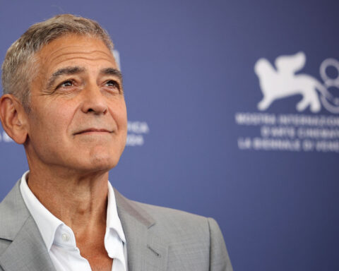 George Clooney is farming and driving a tractor. Seriously