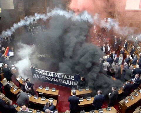 Smoke grenades tossed in Serbian parliament, lawmaker suffers stroke