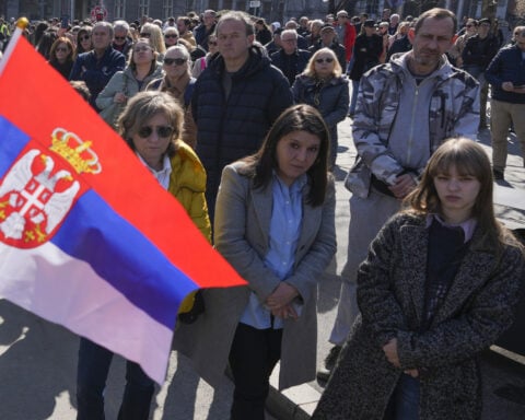 At least 3 Serbian lawmakers injured as smoke bombs and flares thrown in parliament