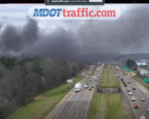 Junkyard fire spreads, creating large plumes of black smoke across interstate