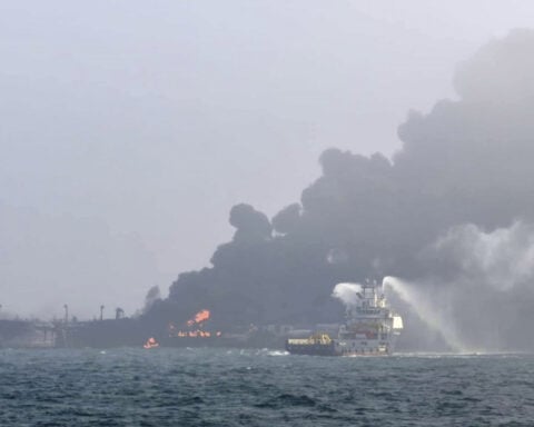 A cargo ship hits a tanker and they catch fire off England, with one crew member missing