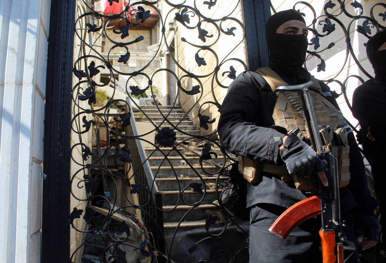 FILE PHOTO: A member of Syrian security forces stands guard at a damaged site, after Israel carried out an air strike on the Syrian capital Damascus on Thursday