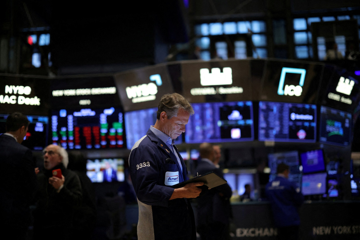 FILE PHOTO: Traders work on the floor of the NYSE in New York