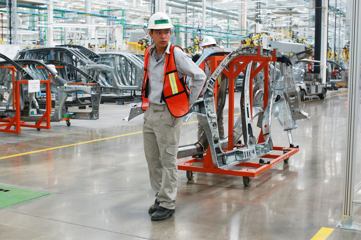 An employee transports test parts for a Volkswagen Tiguan inside the company's plant in Puebla, Mexico, on October 13, 2016.