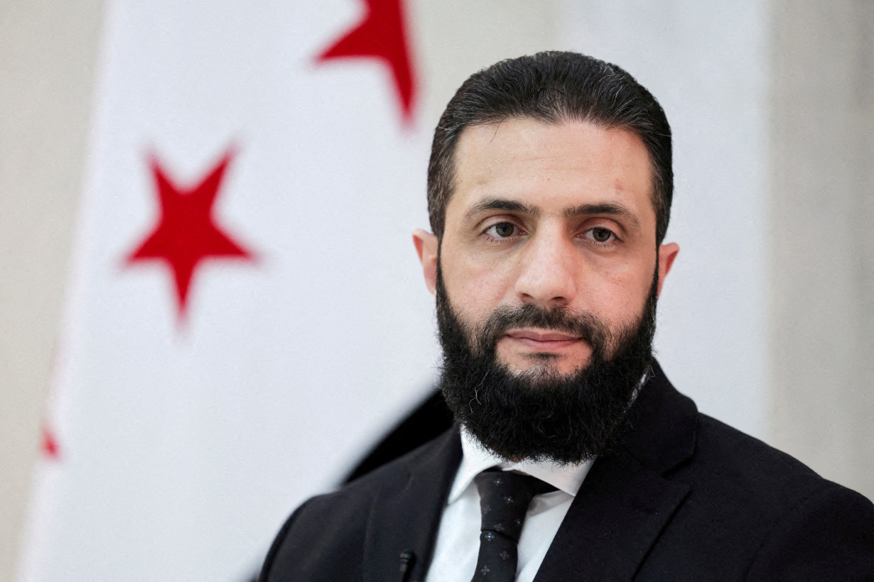 FILE PHOTO: Syria's interim President Ahmed al-Sharaa attends an interview with Reuters