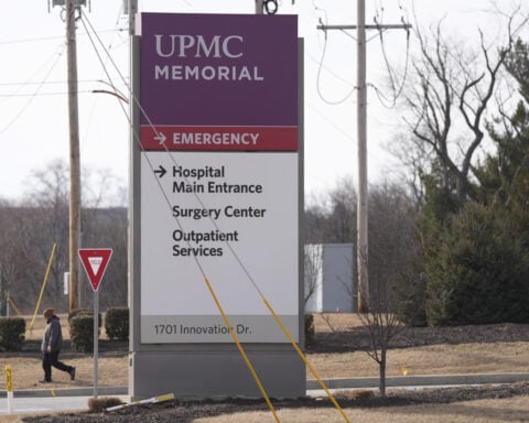 Prosecutor says officer killed in gunman's Pennsylvania hospital attack was hit by fire from police